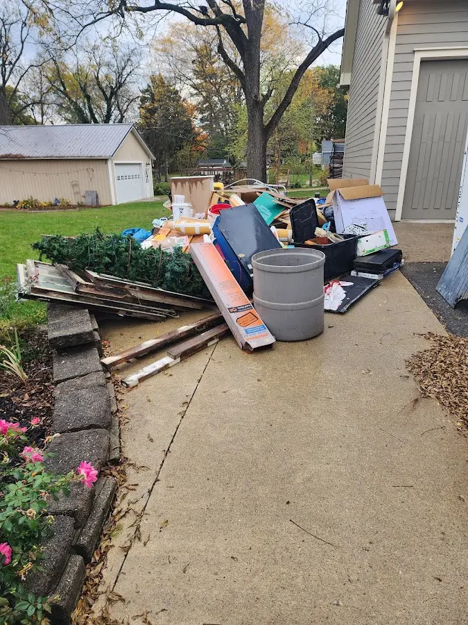 Dumpster being loaded with debris for Residential Dumpster Rental in Charlestown